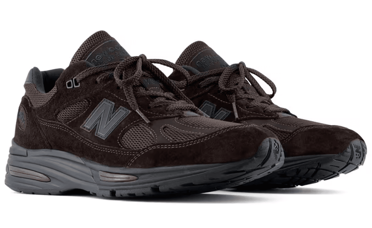New Balance 991v2 Made in UK in monochrome chocolate brown, showing full lateral profile of the heritage silhouette
