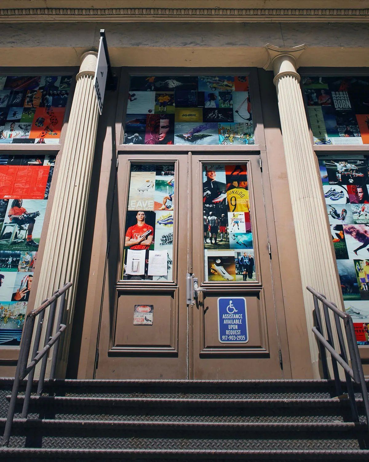 21 Mercer storefront with archival Nike football magazine advertisements and vintage imagery covering windows during World Cup activation