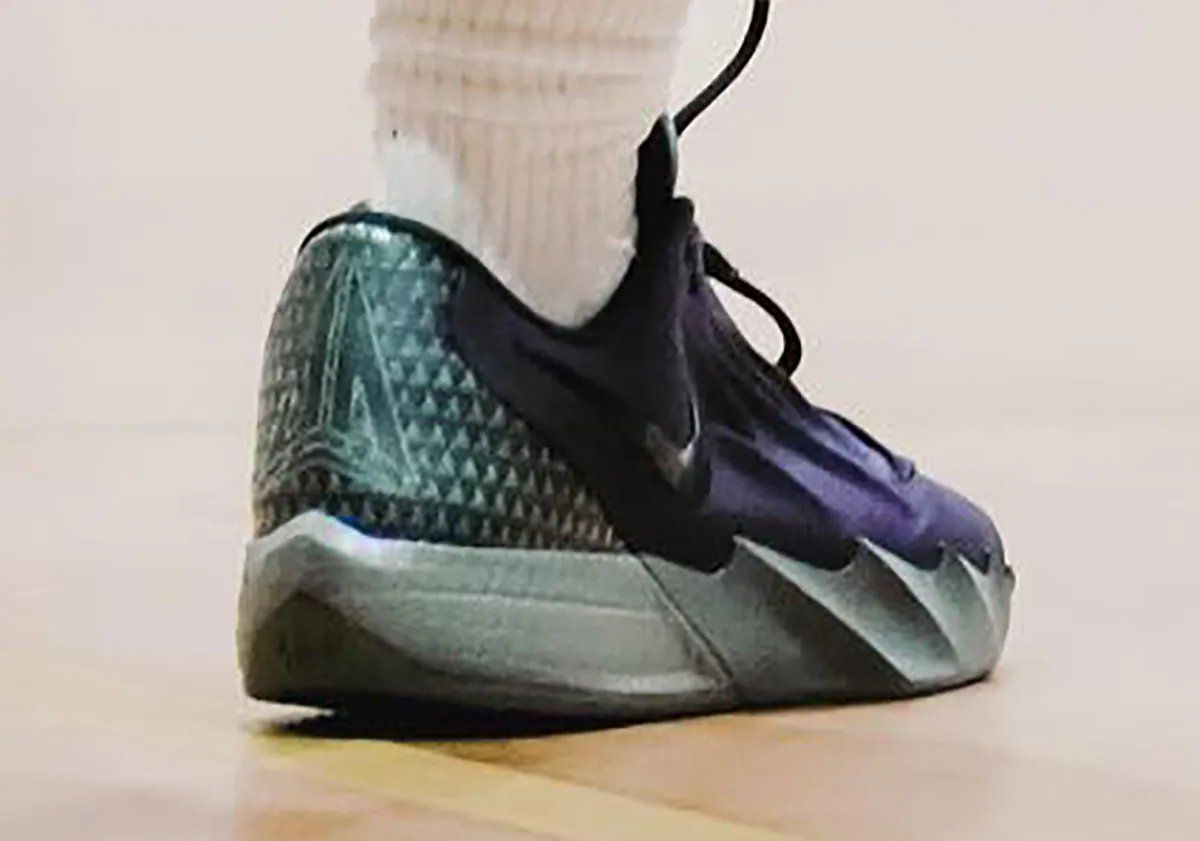 Side profile view of Nike Ja Morant Twelve Time showing wave-sculpted midsole, herringbone traction pattern, and lateral Swoosh branding