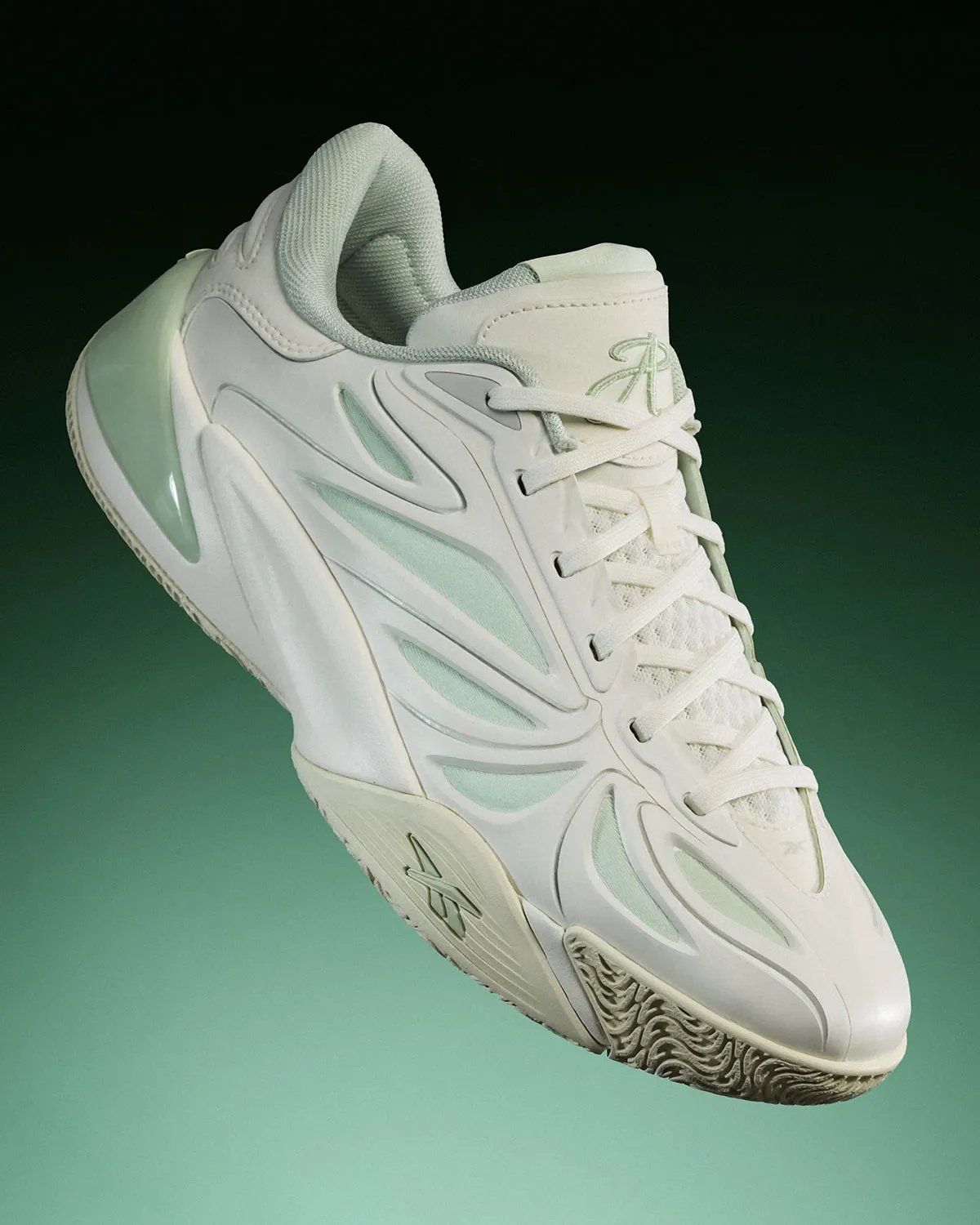Reebok Angel Reese 1 Metal Green and Aqua colorways displayed side by side, showing muted pastel and vibrant aqua treatments with contrasting heel details