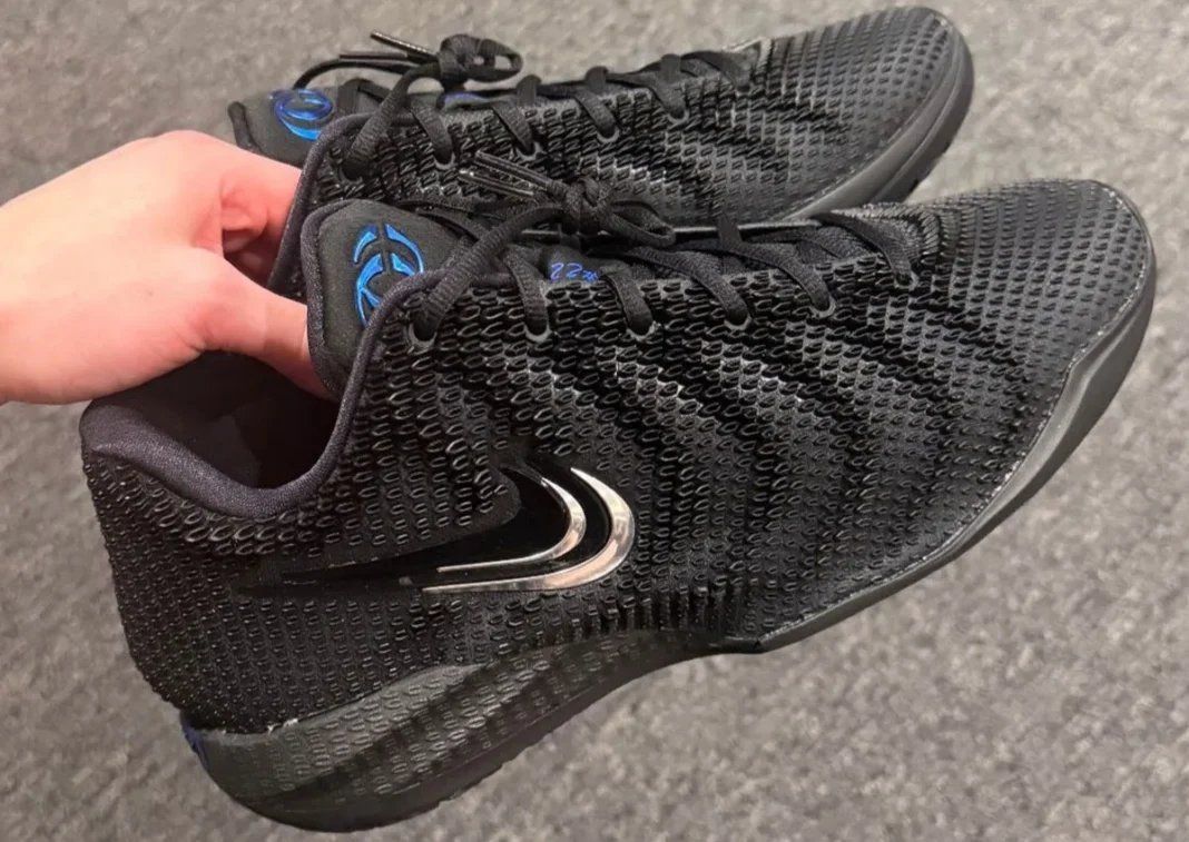 Nike Caitlin 1 "3x Black" colorway featuring black upper with metallic silver and Caitlin Blue accents