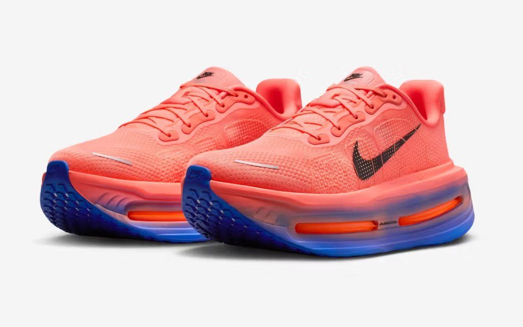 Nike Vomero Premium in Knicks orange and blue colorway, side profile showing cushioned midsole and engineered mesh upper
