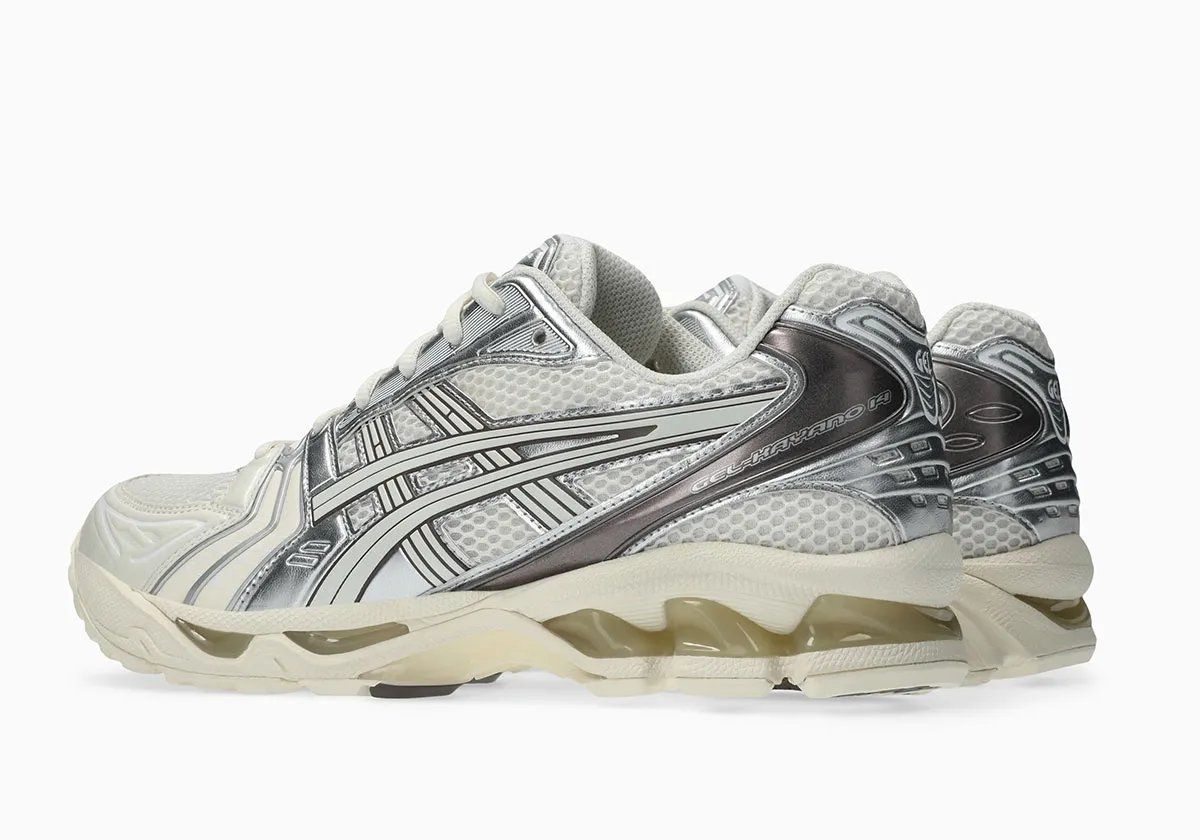 ASICS GEL-Kayano 14 in Cream and Cocoa Powder colorway, showcasing off-white mesh upper with metallic silver side panels and brushed cocoa heel detailing