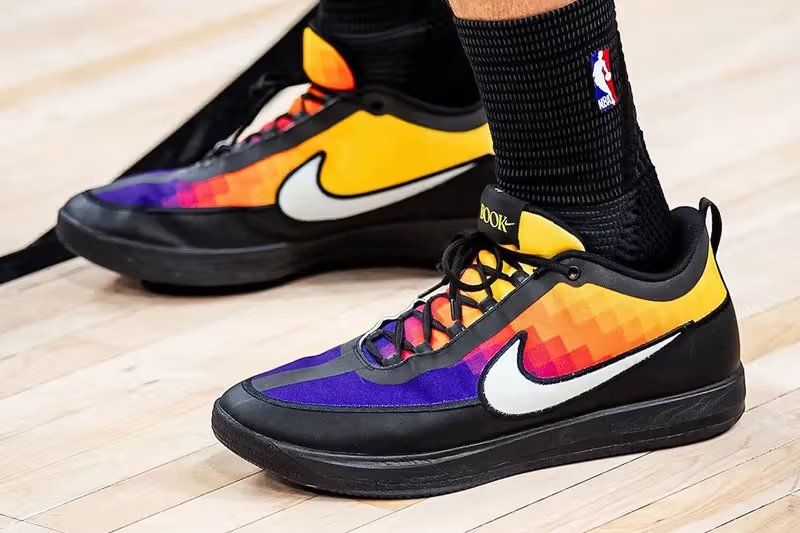 Devin Booker's Nike Book 2 "The Valley" PE featuring a pixel-style sunset gradient in magenta, red, orange, and yellow across the mesh upper