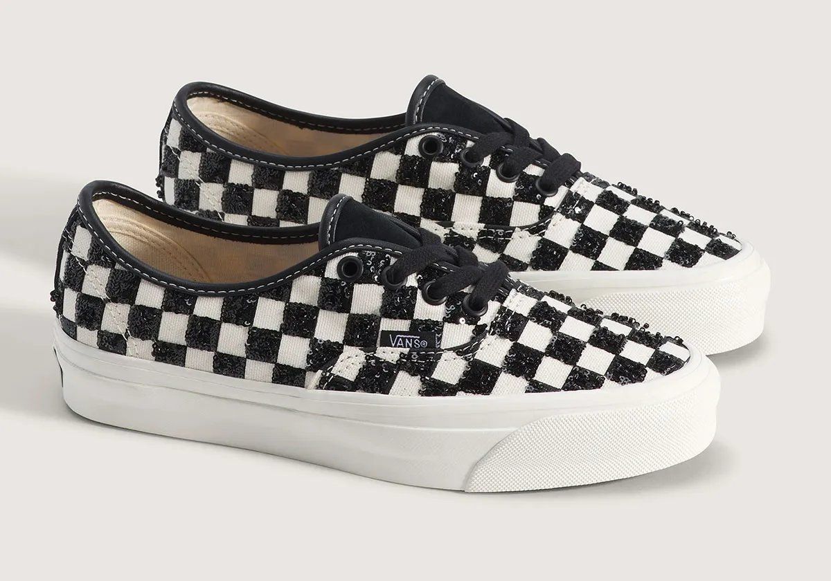 Vans Authentic LX in black checkerboard with sequin embellishment, side view of classic low-top silhouette