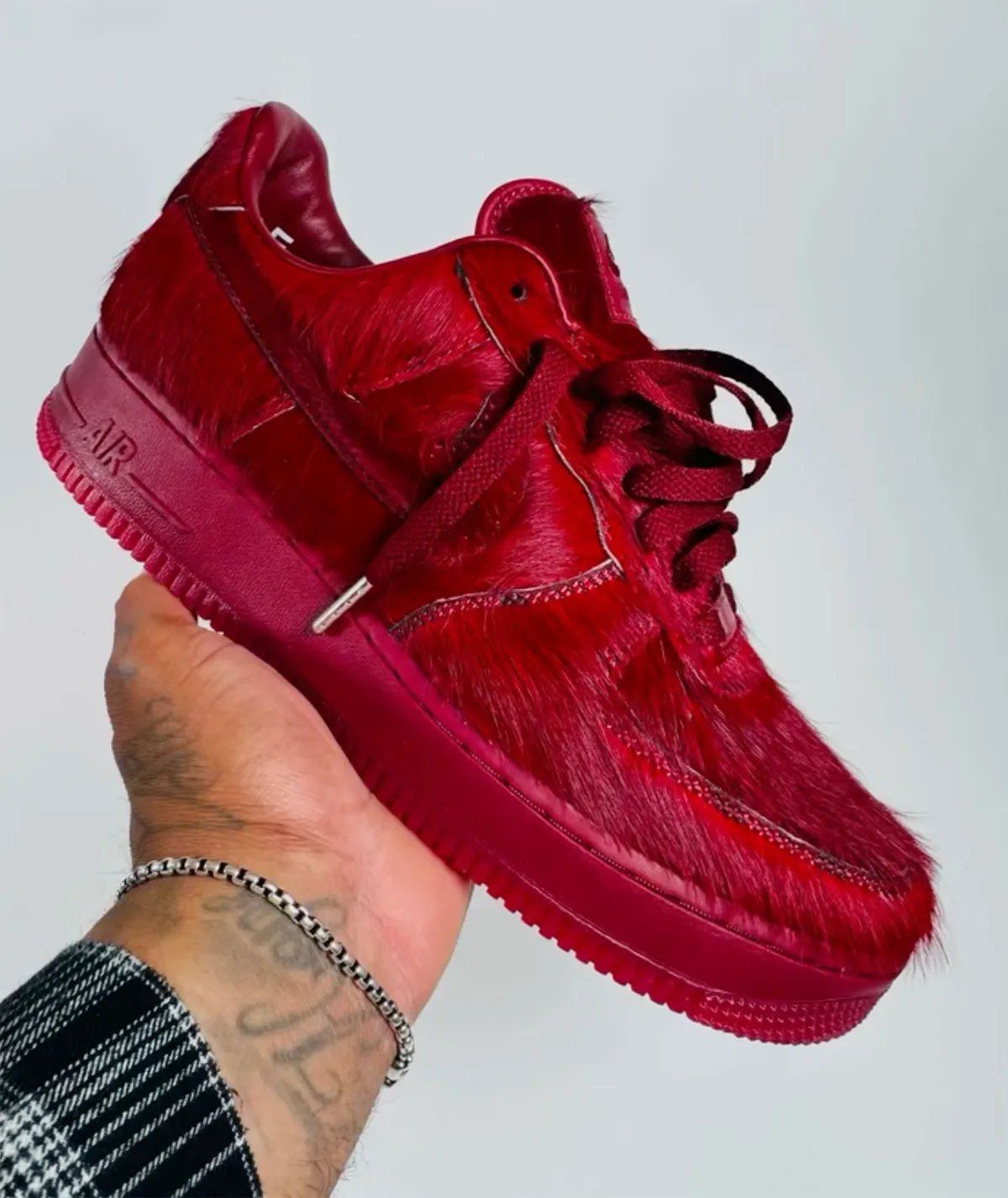Nike Air Force 1 Low covered entirely in red pile fabric, featuring monochromatic red midsole and outsole