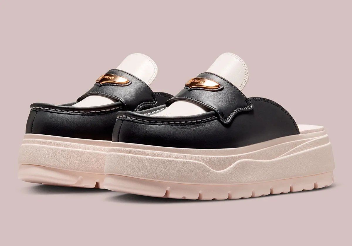 Air Jordan Mule in Chalk and Off Noir with ornamental brogue perforations on the toe box and metallic gold hardware