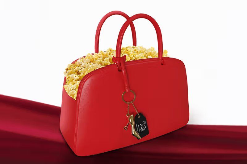AMC Theatres' structured handbag-shaped popcorn bucket for The Devil Wears Prada 2, featuring dual handles and gold hardware