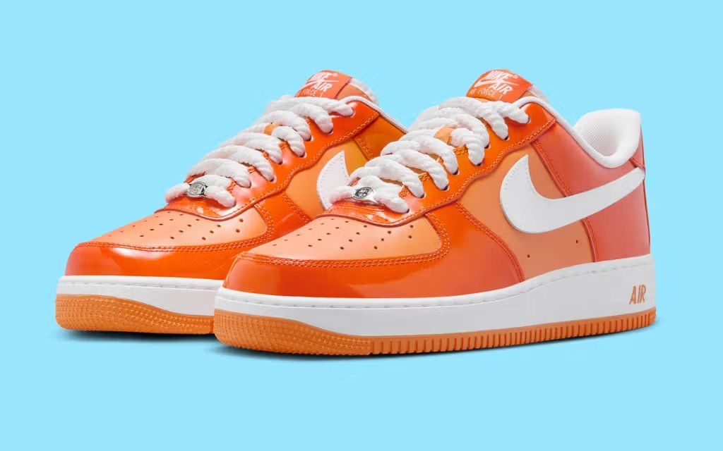 Nike Air Force 1 Low in Patent Safety Orange, featuring high-gloss orange leather upper with white midsole