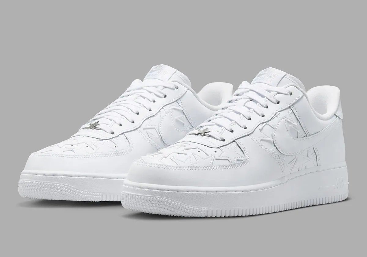 Nike Air Force 1 Low in Triple White with star-motif leather patches on the quarter panel and toe box
