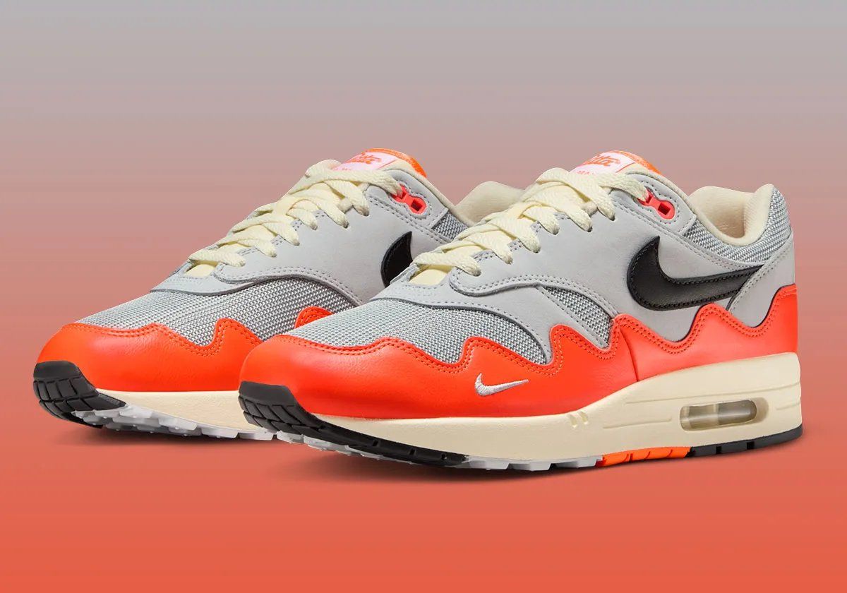 Patta x Nike Air Max 1 Hyper Crimson sneaker, side profile view showing exposed Air unit and classic silhouette