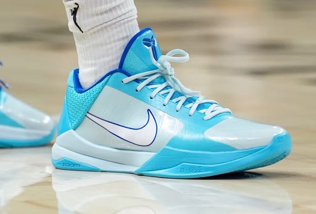 Caitlin Clark's Nike Kobe 5 Protro in the Midwest Lakes colorway, featuring cool-toned blue and regional design elements