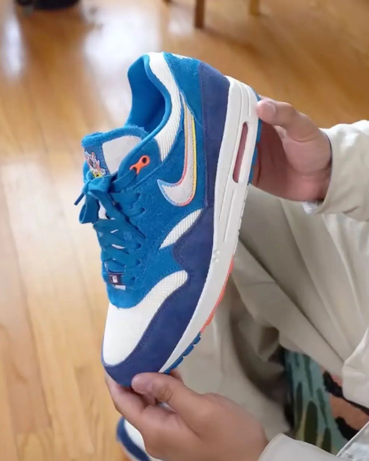Nike Air Max 1 in Brewers City Connect colorway featuring blue suede upper with rainbow-trimmed Swoosh