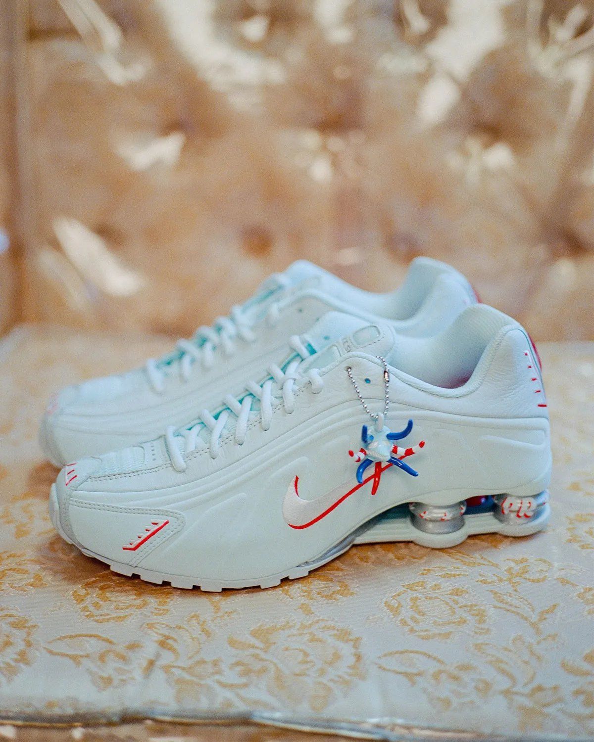 Nike Shox R4 Puerto Rico colorway featuring flag-inspired palette and Vejigante mask charm detail