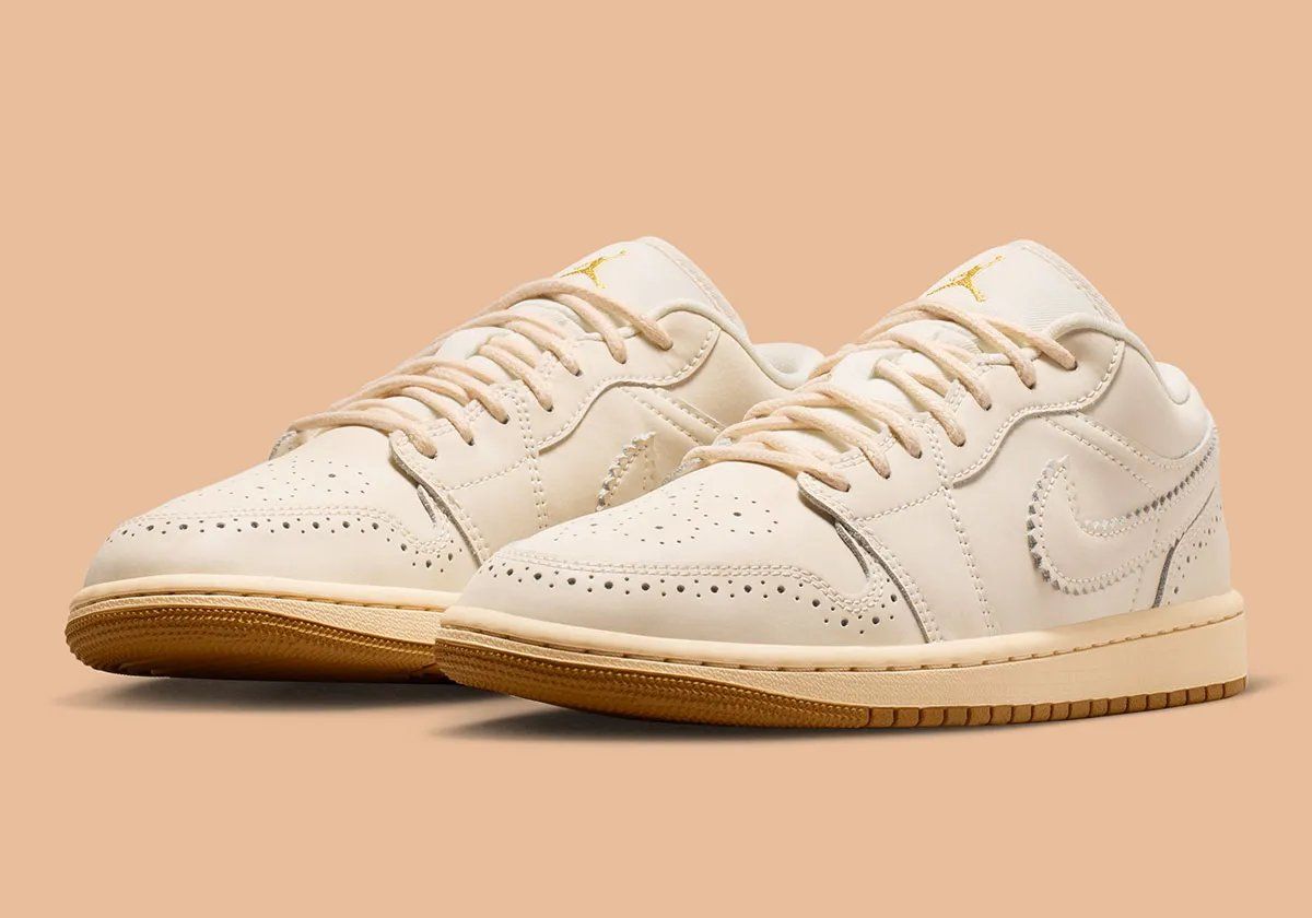 Air Jordan 1 Low in Brogue colorway featuring off-white leather with gold embroidery and rope laces