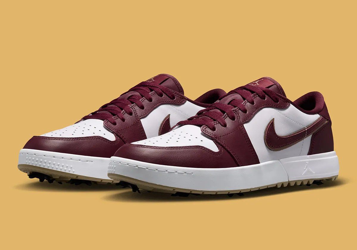 Air Jordan 1 Low Golf Spike in Dark Team Red showing burgundy overlays, khaki outsole, and strategic spike placement