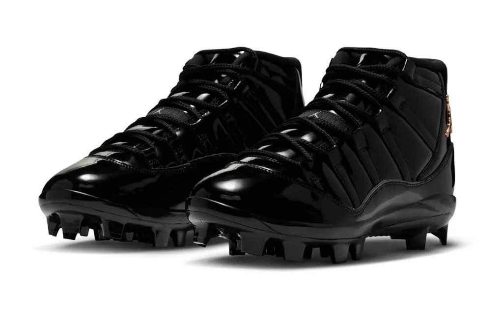 Jordan Air Jordan 11 in black and gold colorway, showing patent leather mudguard and silhouette