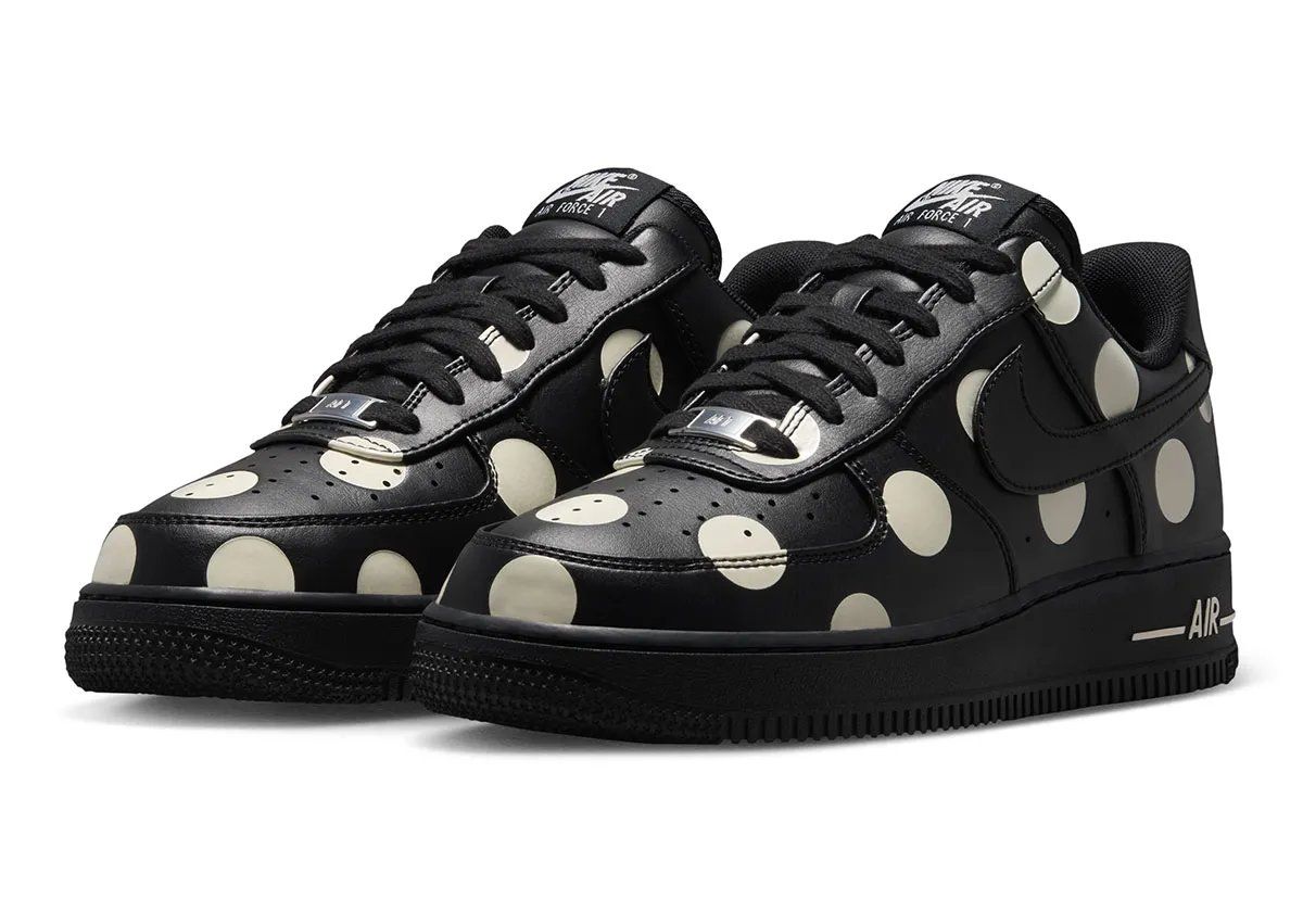 Nike Air Force 1 Low in black leather with cream polka dots, women's colorway, overhead view showing dot pattern across upper