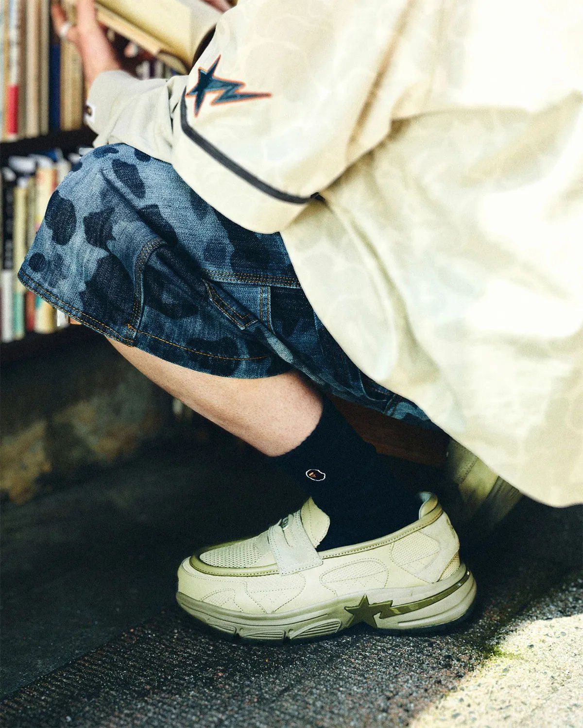 BAPE Loafer STA in light brown colorway, showing laceless loafer upper with textured pocked material and jagged mudguard detailing