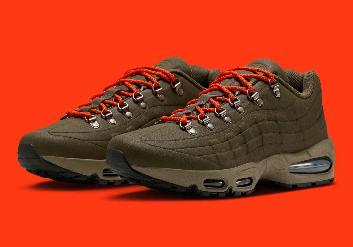 Nike Air Max 95 I-95 in Medium Olive with orange laces, showing molded shell construction and metal d-ring eyelets