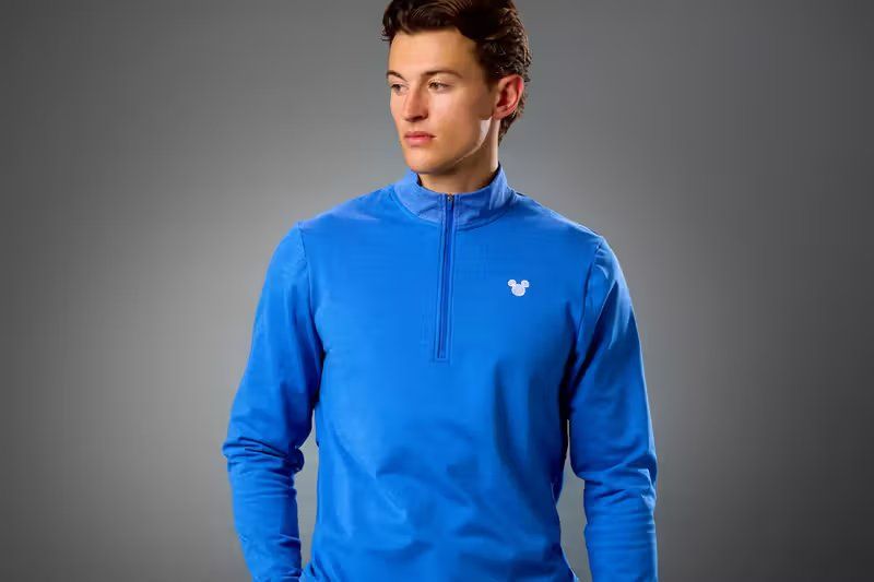 Nike x Disney 2026 golf collection featuring Mickey Mouse Tour Half-Zip and Minnie Mouse Icon Dri-FIT Polo with embroidered character details
