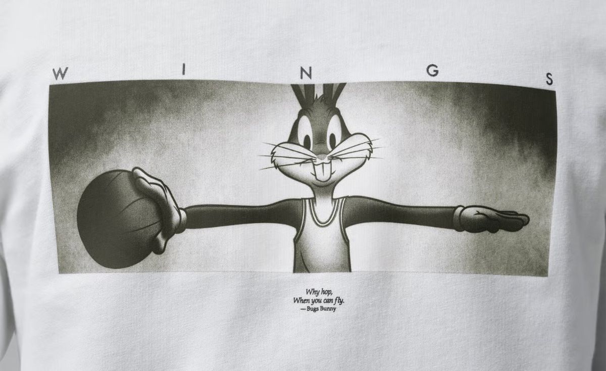 Jordan Brand Space Jam Bugs Bunny Wing T-Shirt in black with outstretched arms graphic and 'Why hop, when you can fly' tagline