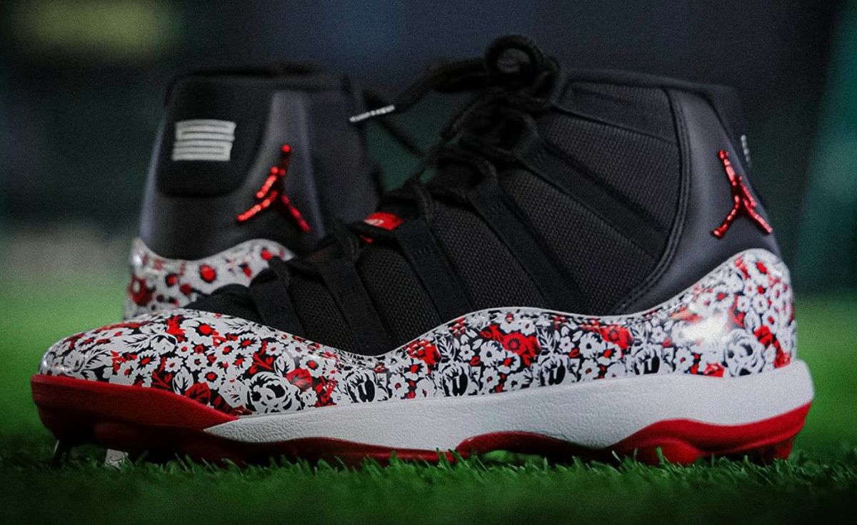 Yomiuri Giants Air Jordan 11 PE cleat featuring black upper with red and white floral print, red cleat plate, and metallic red Jumpman branding
