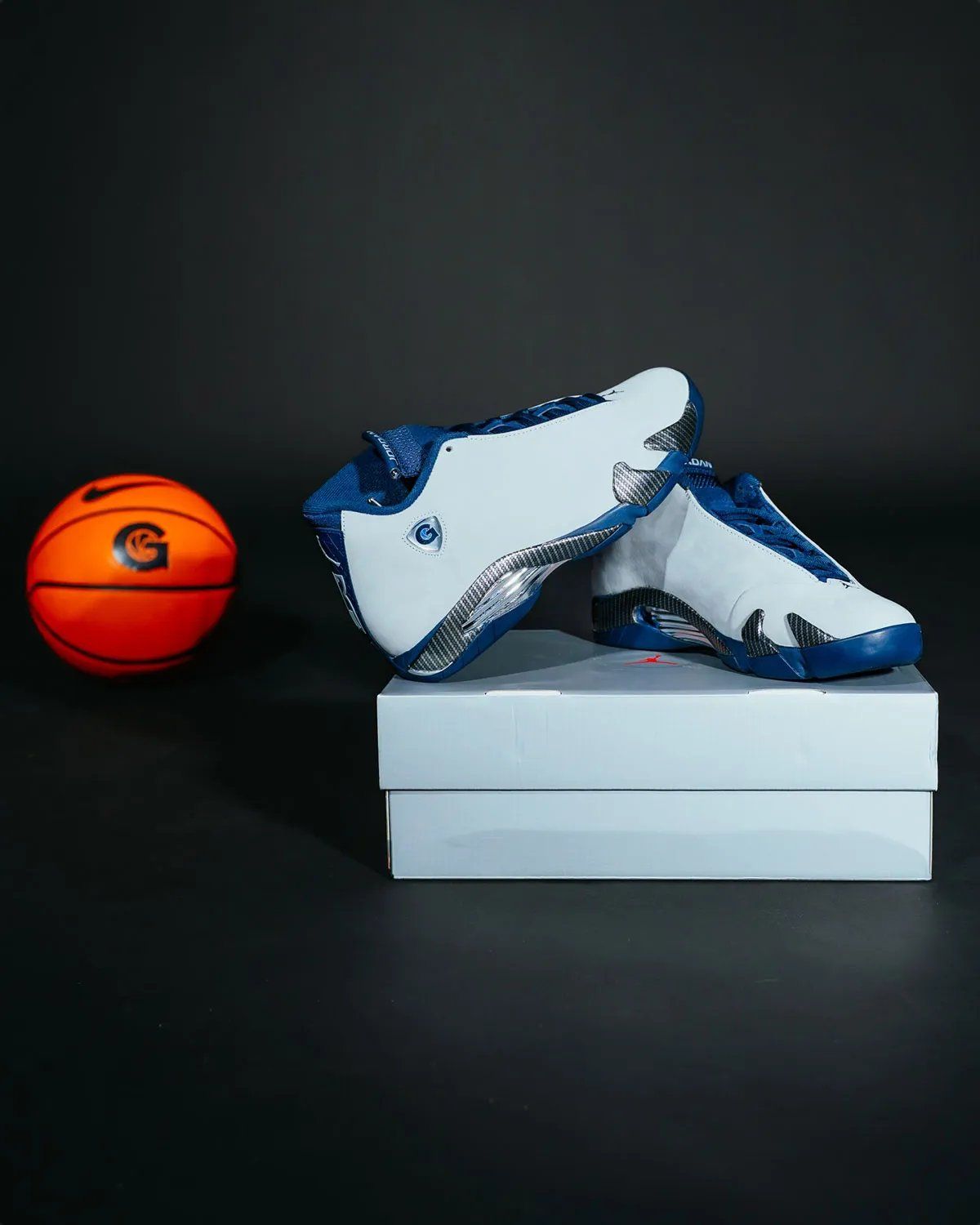 Air Jordan 14 PE in light grey nubuck with navy accents and carbon fiber midsole, Georgetown G logo on lateral shield