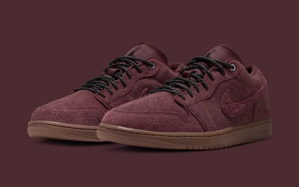 Air Jordan 1 Low Dark Team Red with gum rubber sole, showing wine-toned leather upper and skate-influenced outsole