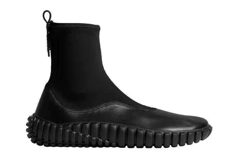 Bottega Veneta Tide sneaker in black calfskin leather, side profile view showcasing architectural silhouette