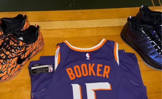 Devin Booker previewing the Nike Book 2 Eggplant Foam in metallic purple with black Swoosh and 3M reflective accents