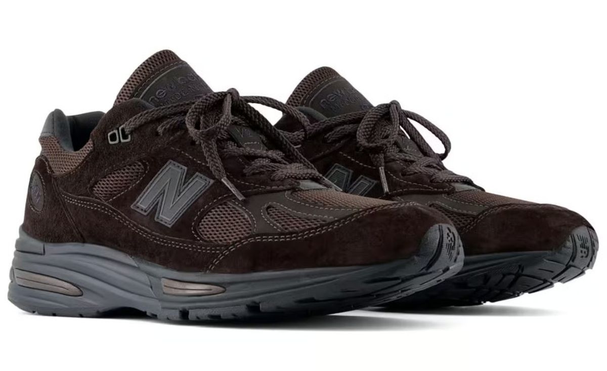 New Balance 991v2 Made in UK in monochrome chocolate brown, showing full lateral profile of the heritage silhouette