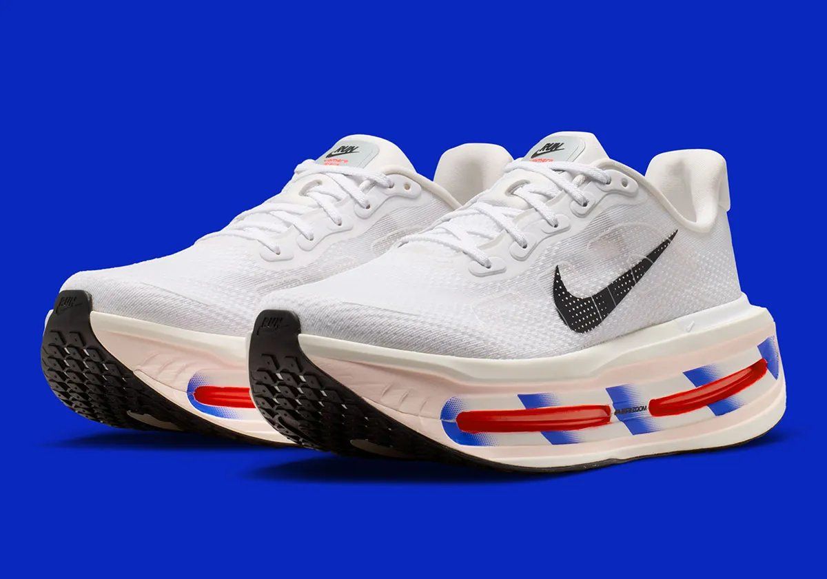 Nike running collection in white with royal blue diagonal midsole striping across Zoom Air units