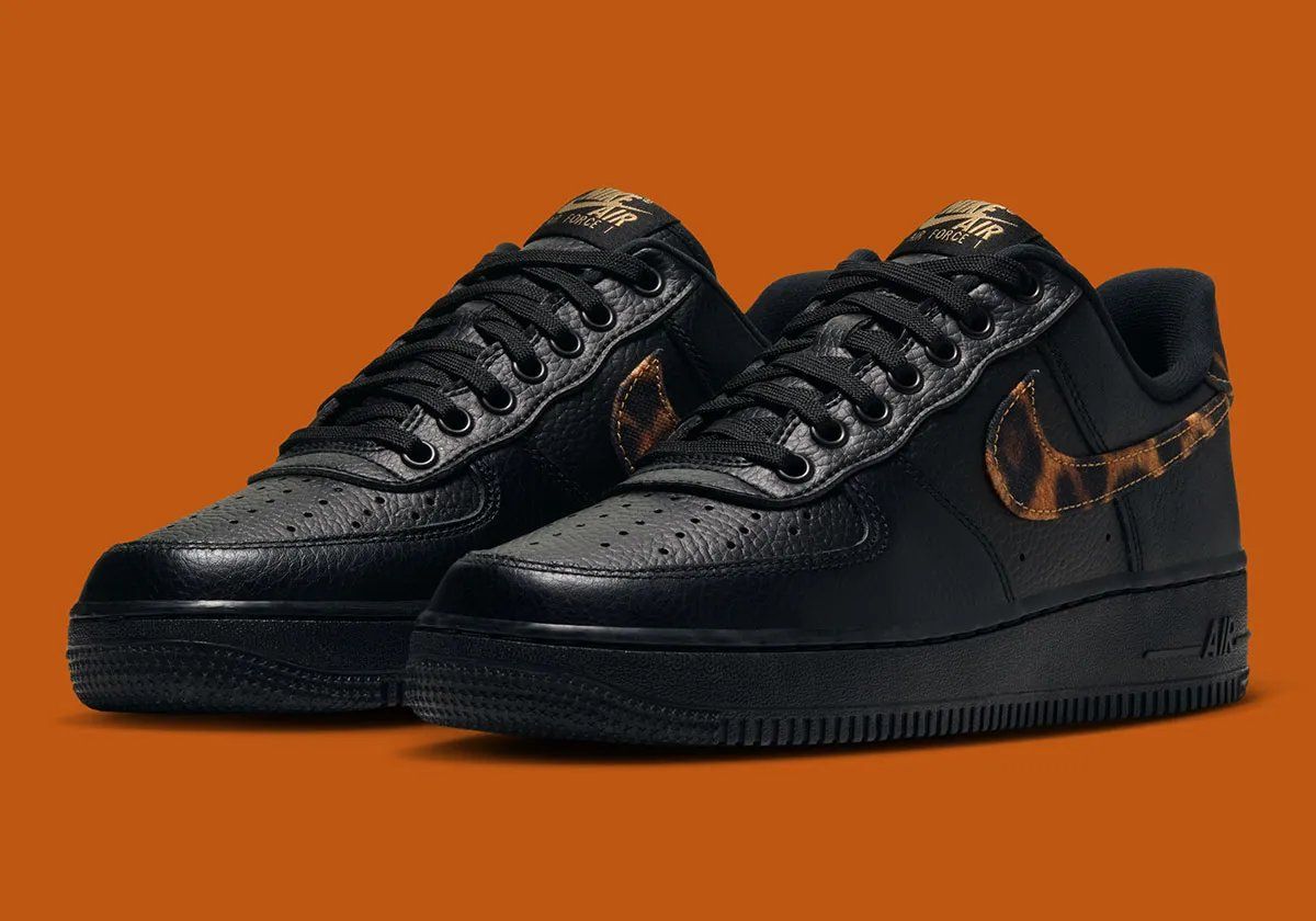 Nike Air Force 1 Low in black tumbled leather with leopard print detailing on the Swoosh and heel tab