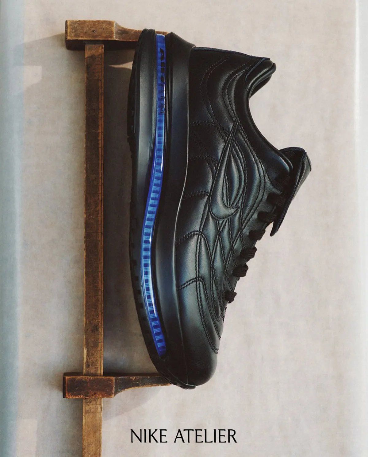 Nike Atelier Merc Premium hybrid sneaker featuring black Mercurial R9 upper with Pegasus Premium midsole, lateral three-quarter view