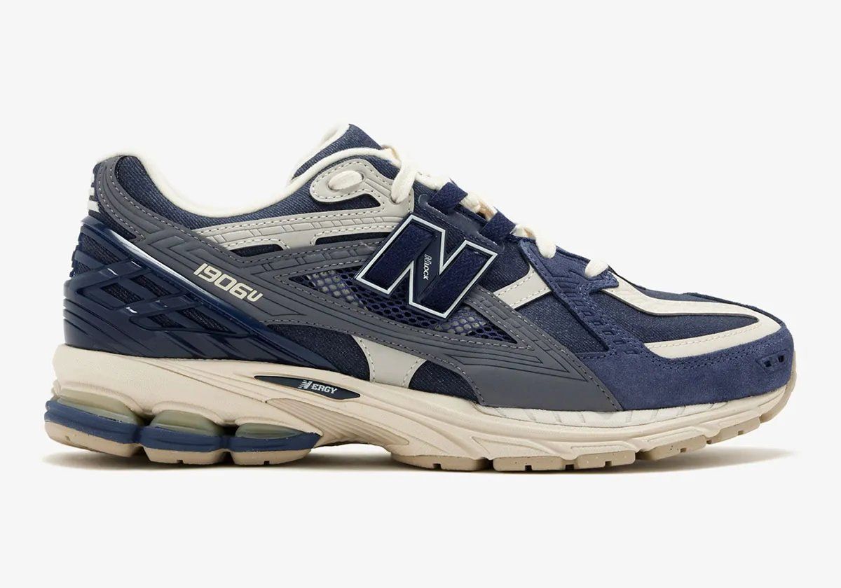 New Balance 1906U in navy and off-white colorway, showing side profile of the lifestyle sneaker