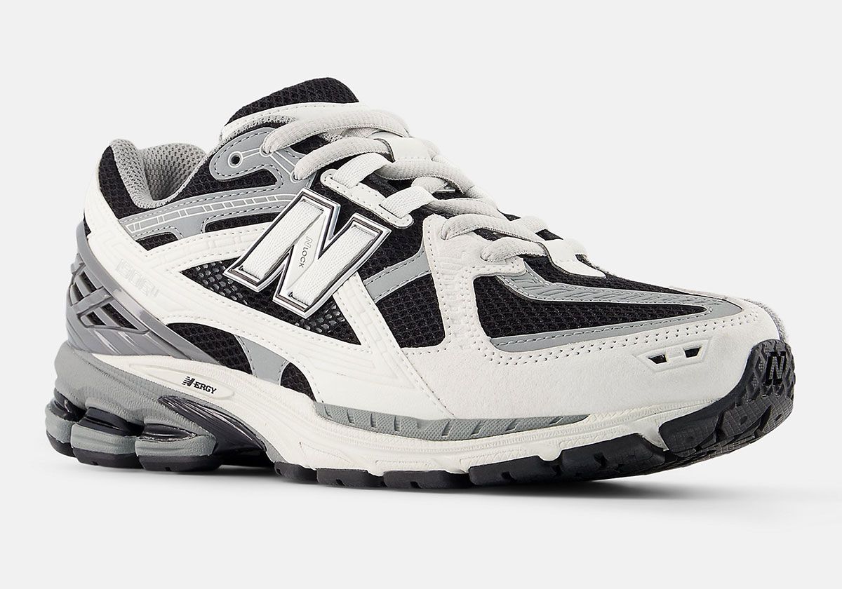 New Balance 1906U in black and white colorway, showing layered upper construction and side profile