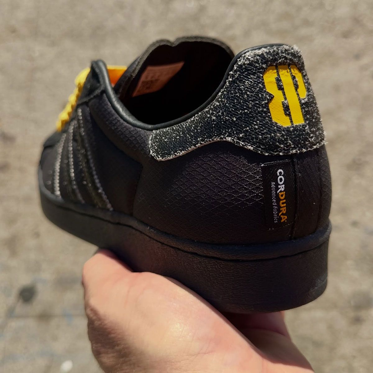 adidas Superstar ADV in all-black with distressed leather detailing, yellow laces, and Cordura construction from the Brooklyn Projects x Anthrax collaboration.