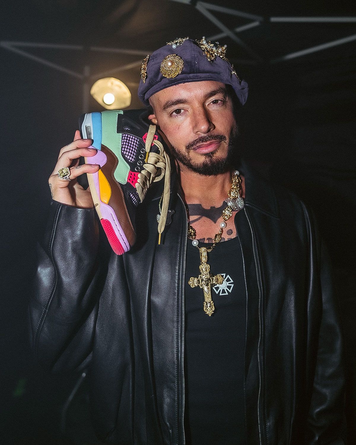 J Balvin x Air Jordan 4 featuring brown leather mudguard and pastel patchwork upper in pink, yellow, green, and blue tones