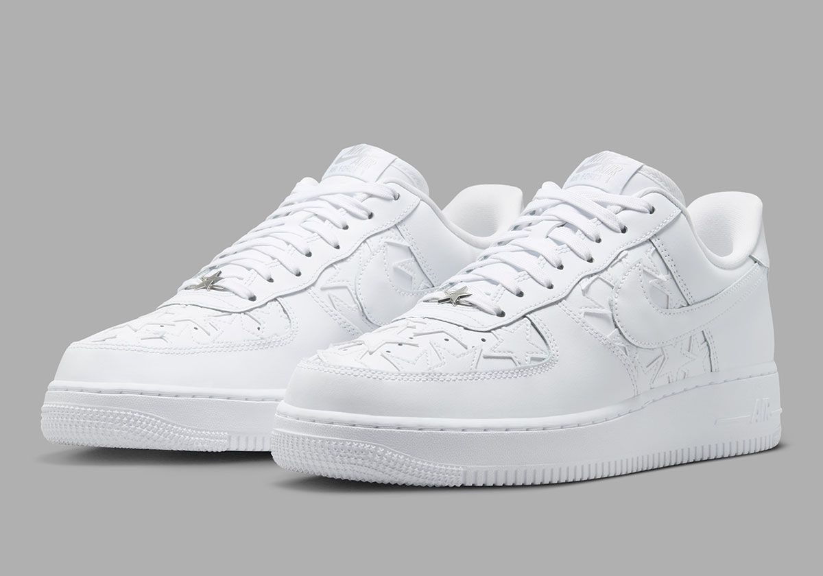Nike Air Force 1 Low in Triple White with star-motif leather patches on the quarter panel and toe box