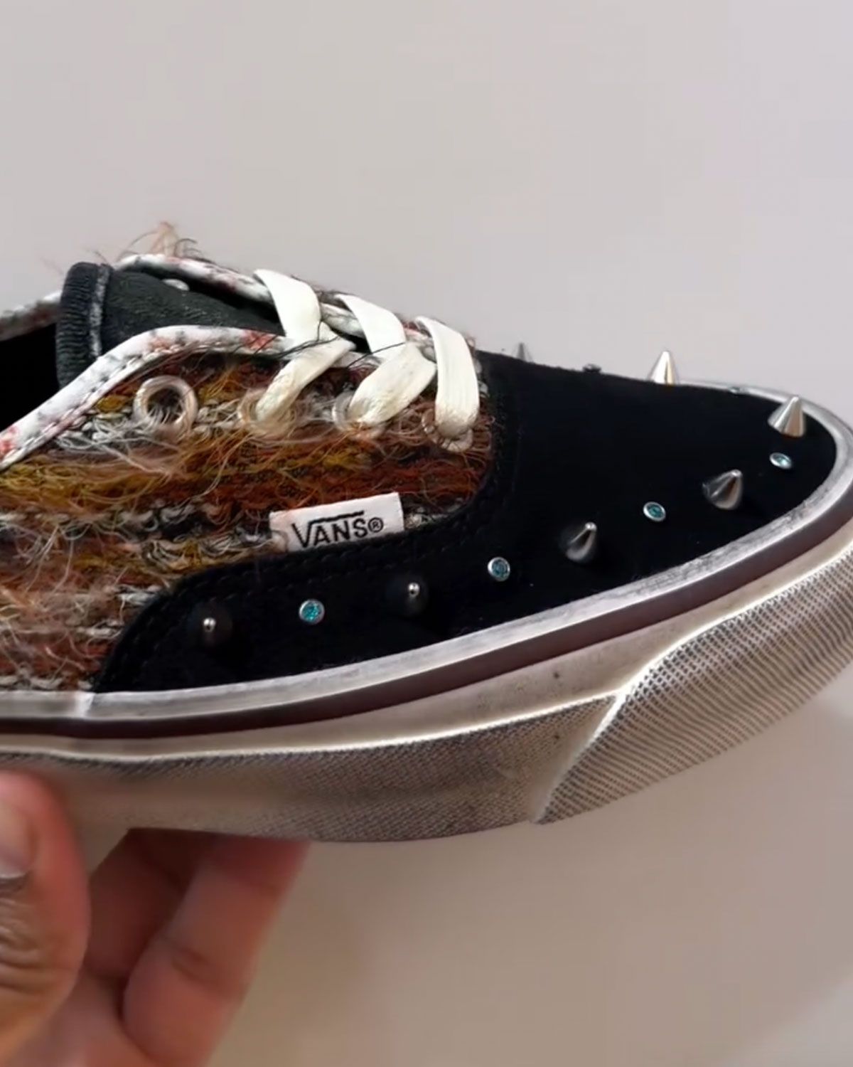 Vans Authentic with distressed yarn quarter panels and spiked accents, designed by Greg Betty, showing earthy tones and jet-black colorway