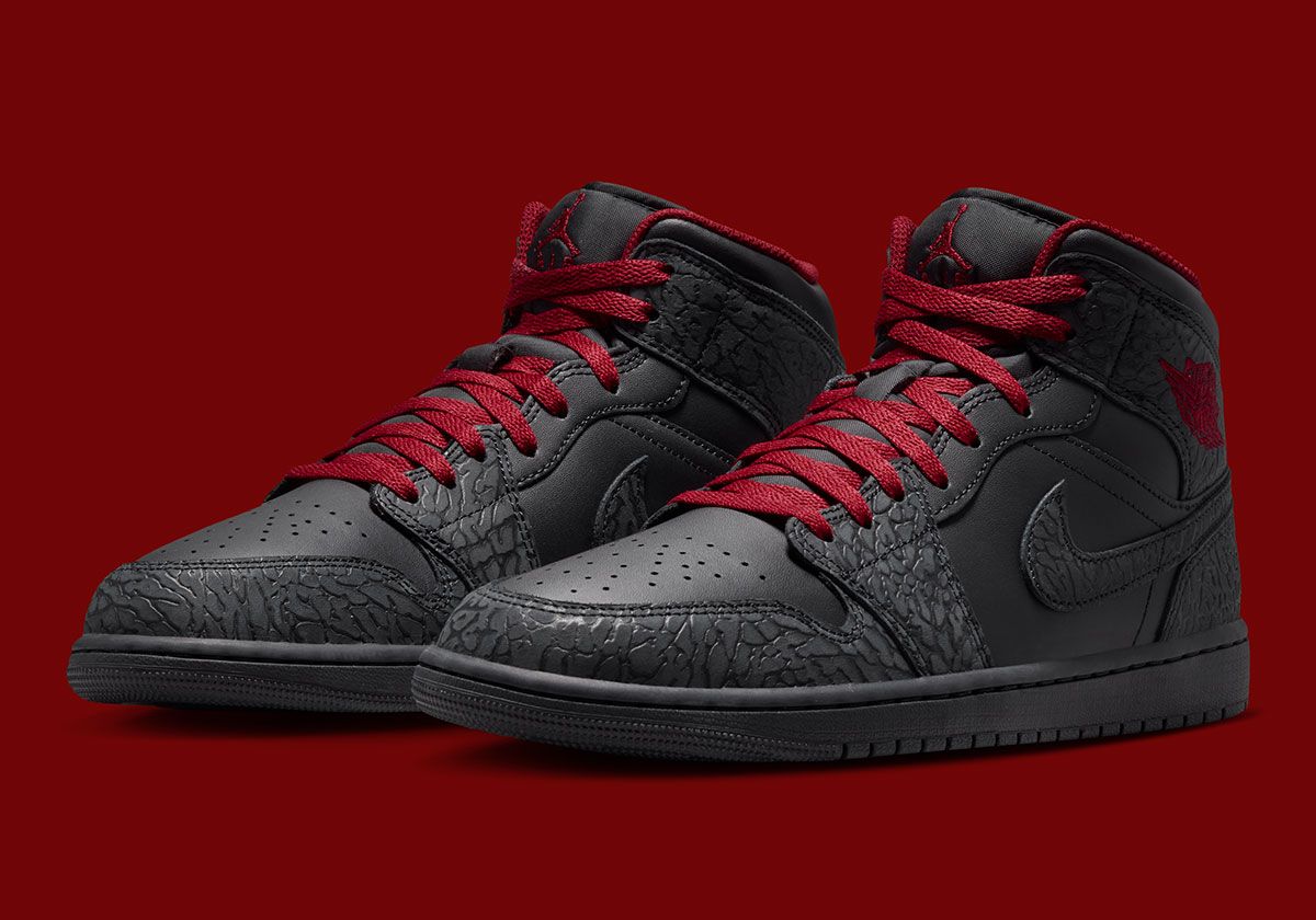 Air Jordan 1 Mid in black with elephant print detailing on toe, heel, and Swoosh, featuring Tough Red accents