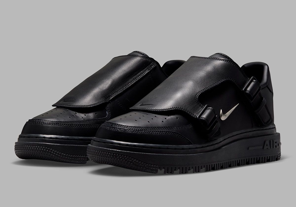 Nike Air Force 1 Low Luxe in black with buckled leather tongue and silver metal Swoosh accents