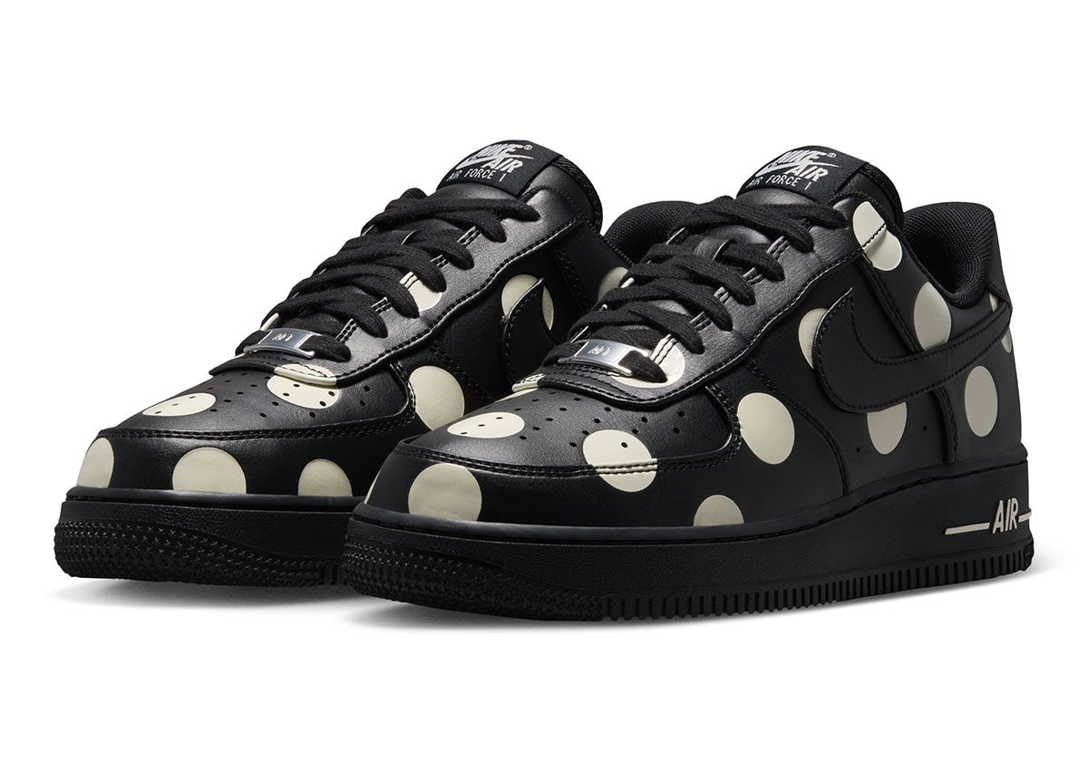 Nike Air Force 1 Low in black leather with cream polka dots, women's colorway, overhead view showing dot pattern across upper