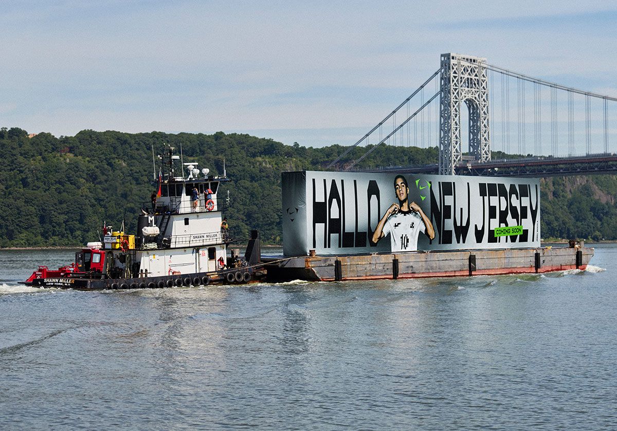 Nike Hudson River billboard teasing Germany's 2027 national team kit with 'Hallo New Jersey' messaging, featuring Jamal Musiala