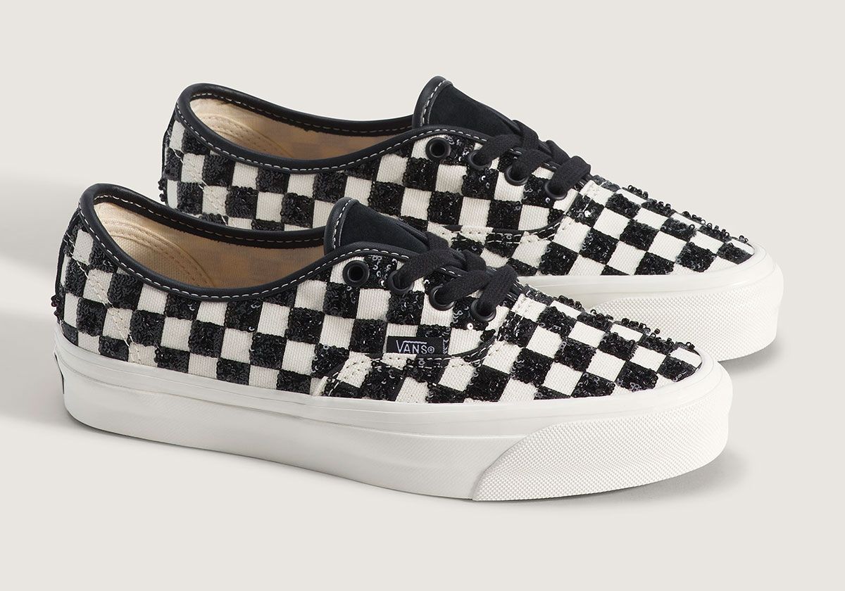 Vans Authentic LX in black checkerboard with sequin embellishment, side view of classic low-top silhouette