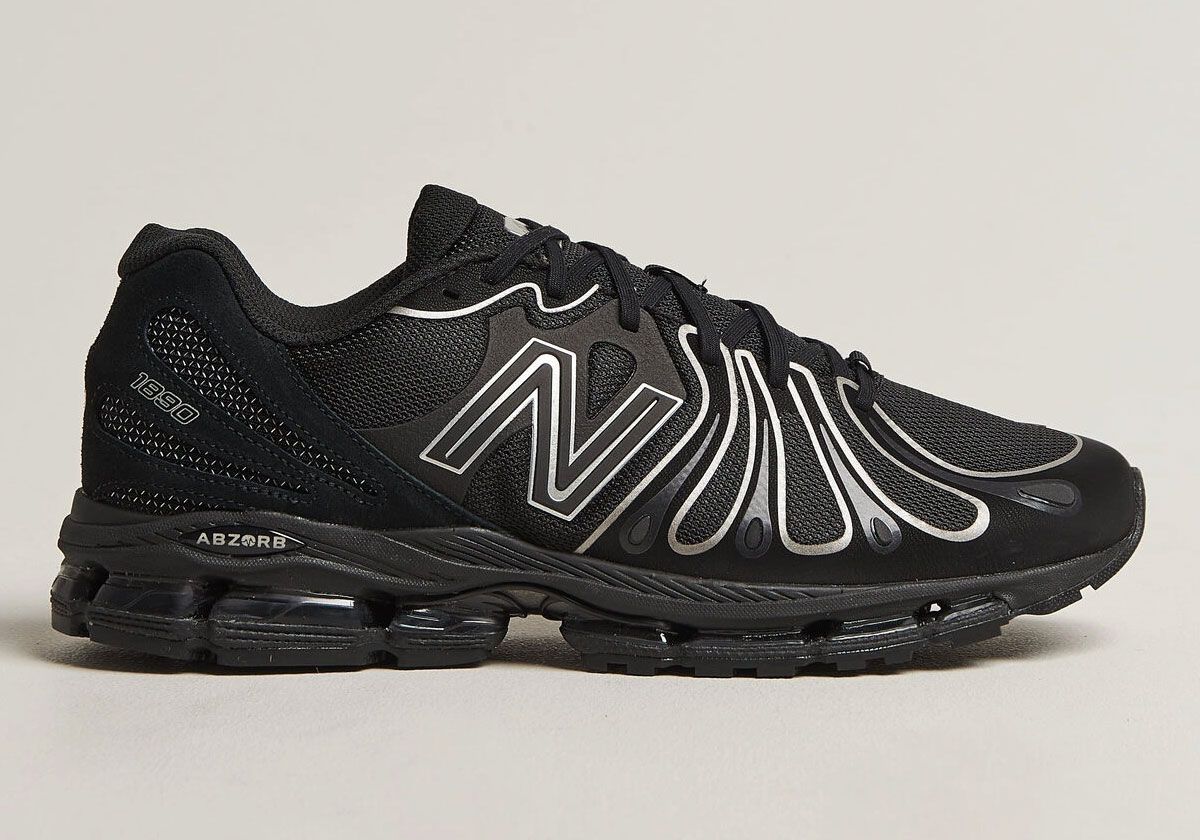 New Balance 1890 in Black/Silver colorway, showing mesh and suede upper with metallic silver trim accents and ABZORB sole unit