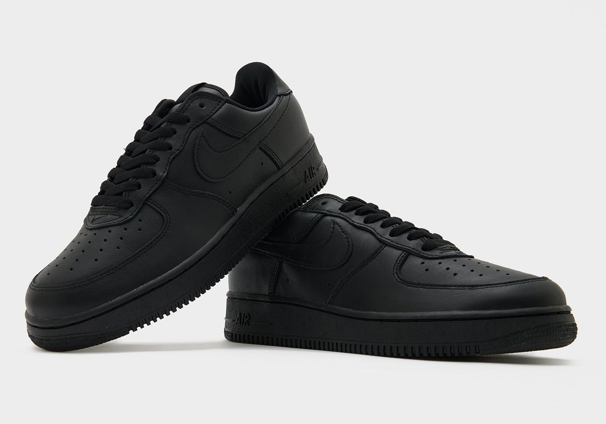 Nike Air Force 1 '01 Triple Black in full black colorway, showcasing the Y2K-era silhouette with slimmer proportions and supple leather construction