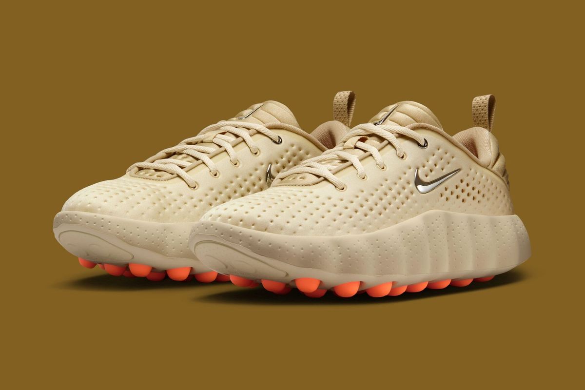 Nike Mind 002 in Light Smoke Grey colorway, full profile view showing neutral grey upper and structured silhouette