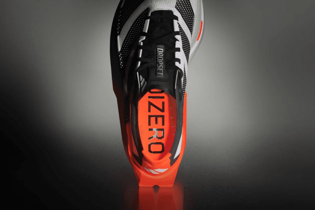 Adidas Adizero Dropset Elite in Solar Red and Core Black colorway, showcasing the lateral stabilization and midsole design
